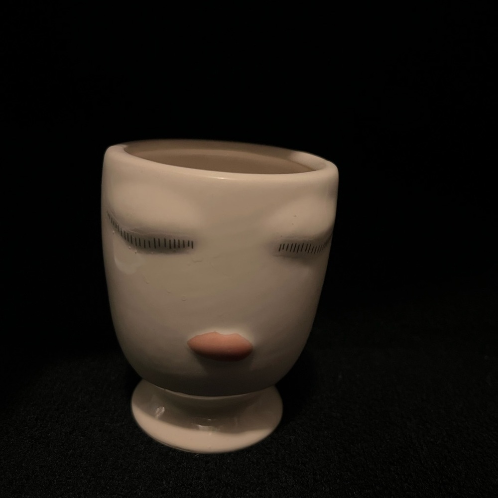 Trinket make up cup with drawn eyes and lips
